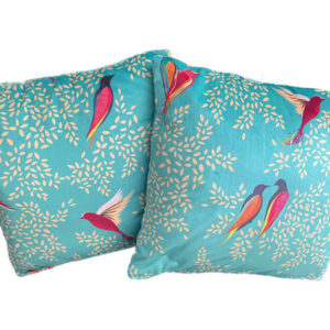A pair of cushions in Sara Miller Green Birds velvet fabric